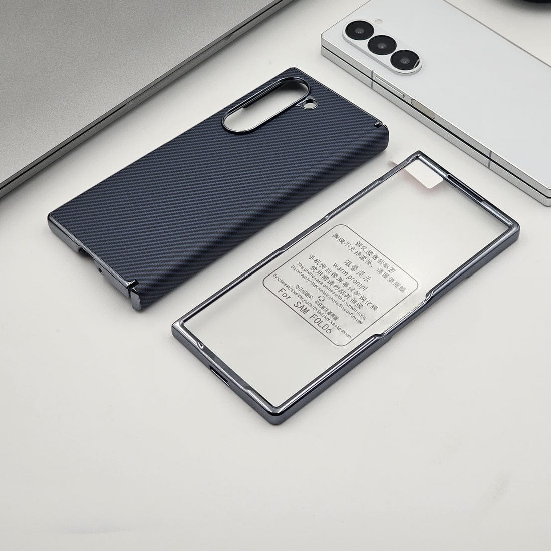 Two phone cases, one black textured and one clear with text, on a light gray surface.