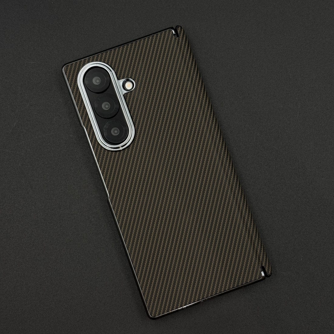 Carbon fiber texture phone case on a dark background